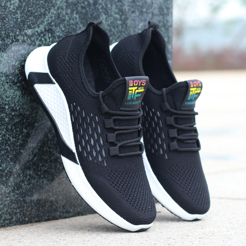 Black and white sneakers with colorful 'BOYS' label on a blurred background