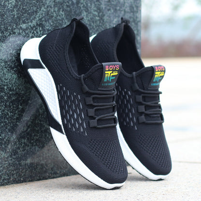 Black and white sneakers with colorful 'BOYS' label on a blurred background