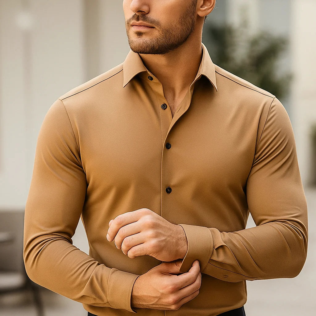 Man wearing a brown button-up shirt with a blurred background