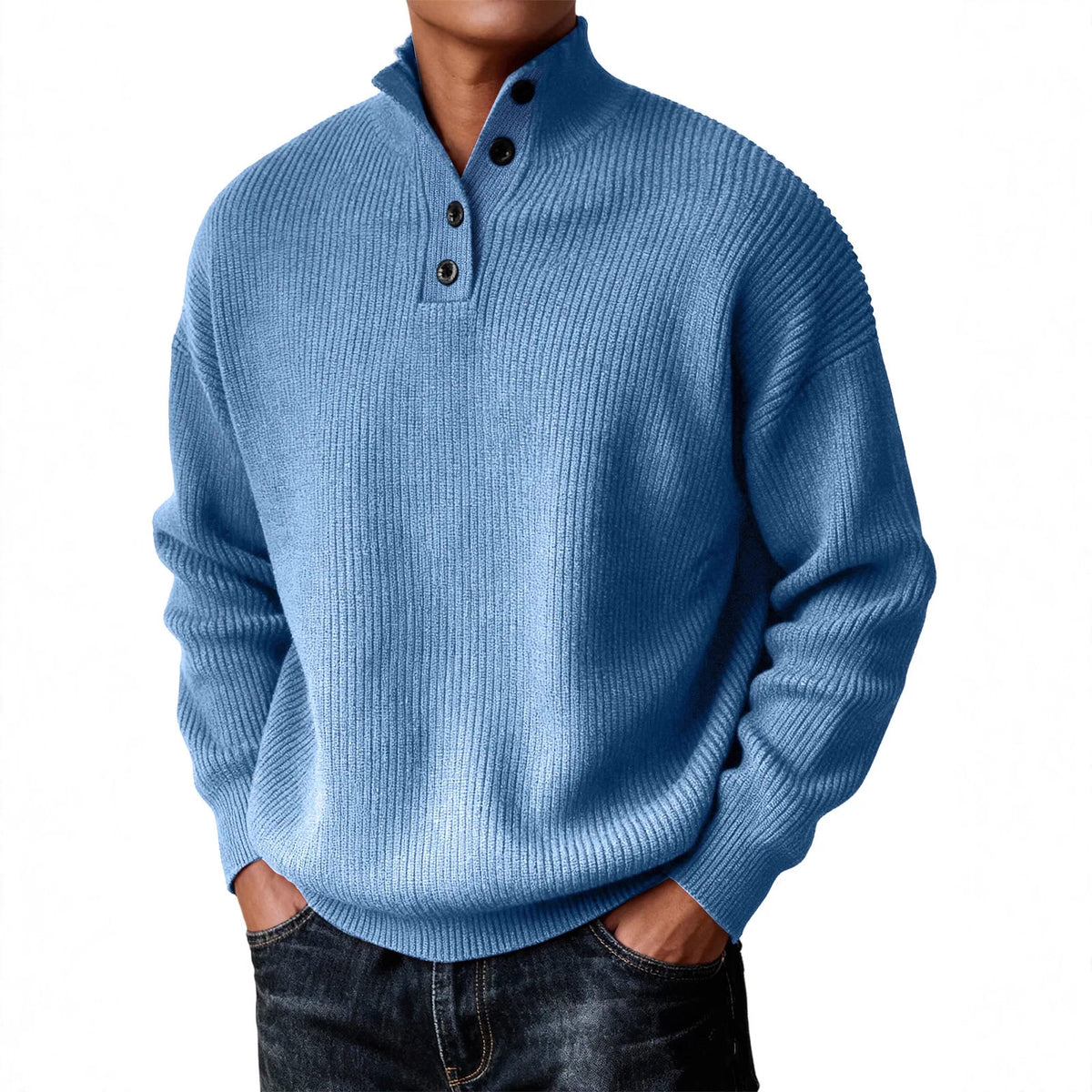 A man wearing a light blue ribbed knit mock-neck sweater with three dark buttons, paired with dark jeans, against a plain white background.